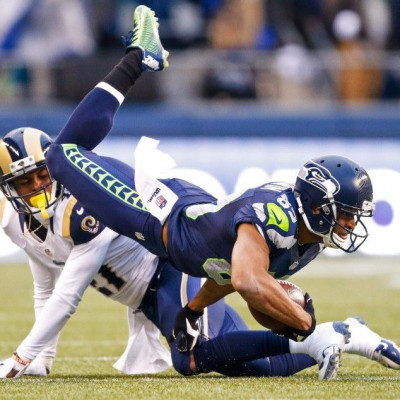 Dec 28, 2014; Seattle, WA, USA; Seattle Seahawks wide receiver Doug Baldwin (89) is tackled after making a reception against the St. Louis Rams during the fourth quarter at CenturyLink Field.