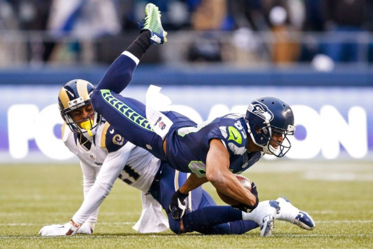 Dec 28, 2014; Seattle, WA, USA; Seattle Seahawks wide receiver Doug Baldwin (89) is tackled after making a reception against the St. Louis Rams during the fourth quarter at CenturyLink Field.