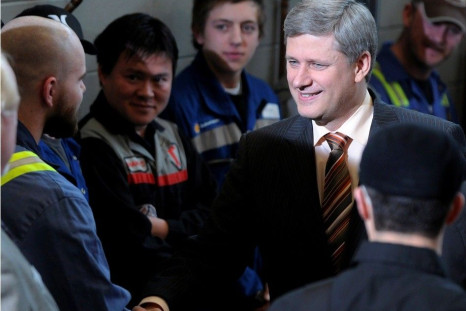 Canada's Prime Minister Stephen Harper shakes hands with NAIT apprentice students