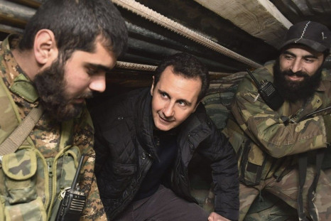 Syrian President Bashar al-Assad (C) talks to soldiers during a visit to Jobar, northeast of Damascus, in this handout photograph distributed by Syria's national news agency SANA on January 1, 2015. Al-Assad visited a district on the outskirts of Dam