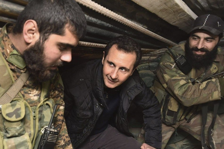 Syrian President Bashar al-Assad (C) talks to soldiers during a visit to Jobar, northeast of Damascus, in this handout photograph distributed by Syria's national news agency SANA on January 1, 2015. Al-Assad visited a district on the outskirts of Dam