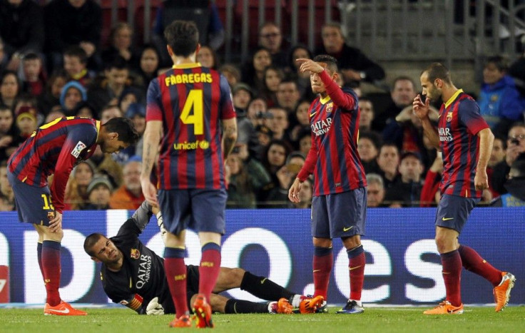 Barcelona&#039;s goalkeeper Victor Valdes (bottom), surrounded by his teammates, gestures as he lies injured on the pitch during their La Liga soccer match against Celta Vigo at Camp Nou stadium in Barcelona March 26, 2014.