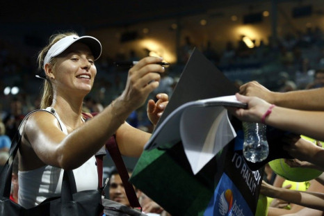 Maria Sharapova of Russia signs autographs for fans after defeating Yaroslava Shvedova of Kazakhstan in their women's singles second round match at the Brisbane International tennis tournament in Brisbane, January 6, 2015. REUTERS/Jason Reed