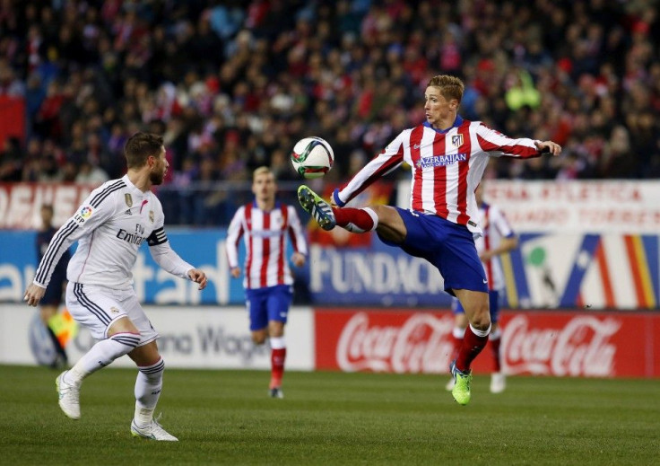 Atletico Madrid&#039;s Fernando Torres (R) controls the ball past Real Madrid&#039;s Sergio Ramos during their Spanish King&#039;s Cup soccer match at Vicente Calderon stadium in Madrid, January 7, 2015.