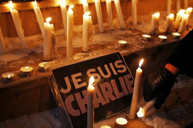 Lighted Candles Next To A Placard Reading 'I Am Charlie' 