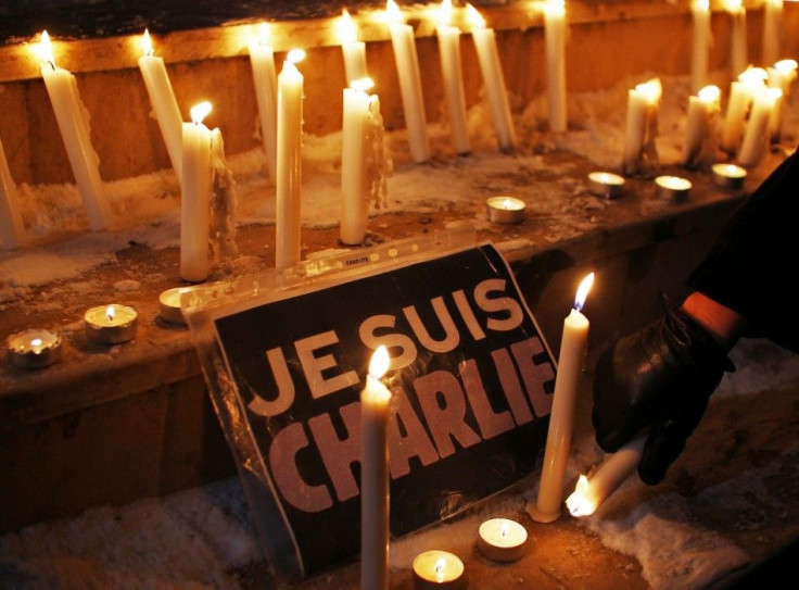 Lighted Candles Next To A Placard Reading 'I Am Charlie' 