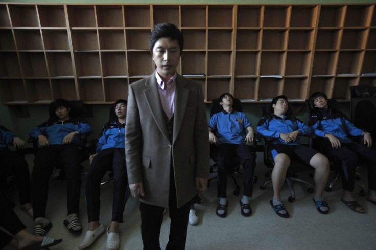 therapist hypnotizes students retaking the college entrance exams, during a meditation session at Deung Yong Moon Boarding School in Kwangju, some 40 km (25 miles) southeast of Seoul October 30, 2012. South Korea's exam hell is an annual event so ful