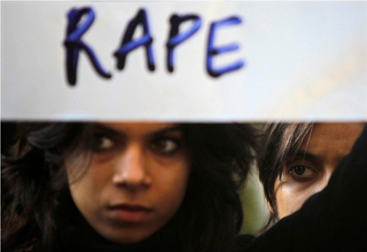 A protester holds a placard during a rally demanding the state government to ensure the safety of women in the capital city