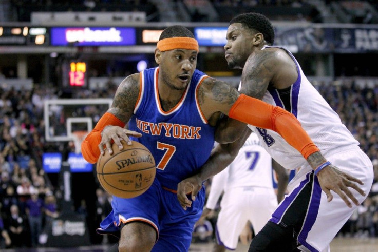 New York Knicks forward Carmelo Anthony (7) dribbles the ball around Sacramento Kings forward Rudy Gay (8) in the first quarter at Sleep Train Arena.