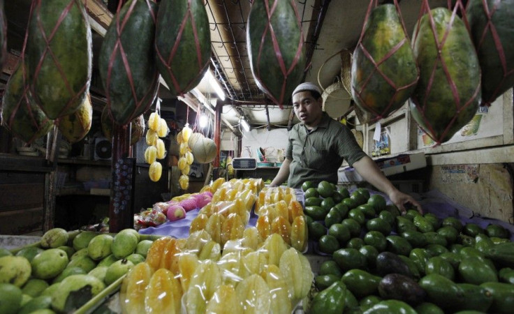 Nata, a fruit vendor, waits for customers at a market in Jakarta March 15, 2011. Nata is a client of Danamon Simpan Pinjam, a unit of Bank Danamon focused on micro lending.