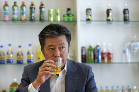 Suntory Beverage and Food President Nobuhiro Torii drinks the company&#039;s Iemon green tea during an interview with Reuters at the company headquarters in Tokyo July 10, 2013.