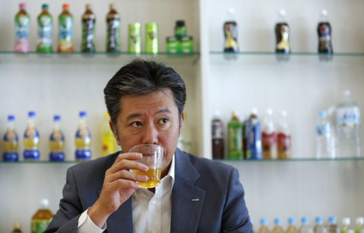 Suntory Beverage and Food President Nobuhiro Torii drinks the company&#039;s Iemon green tea during an interview with Reuters at the company headquarters in Tokyo July 10, 2013.