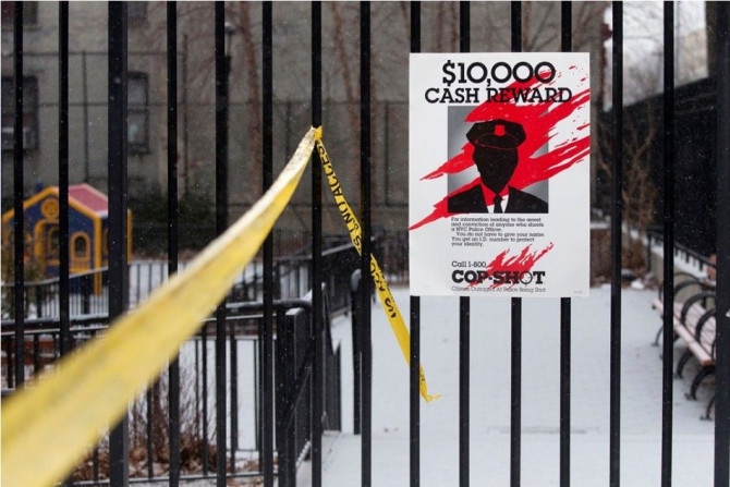 A sign posted near the site of a shooting is seen in the Bronx borough of New York