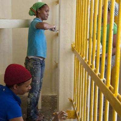 Prisoners paint their cell inside the renovated wing of the Najayo women's prison in San Cristobal, May 12, 2014. Ten years after the country opened its first prison designed with a focus on education and clean living conditions and staffed by graduates f