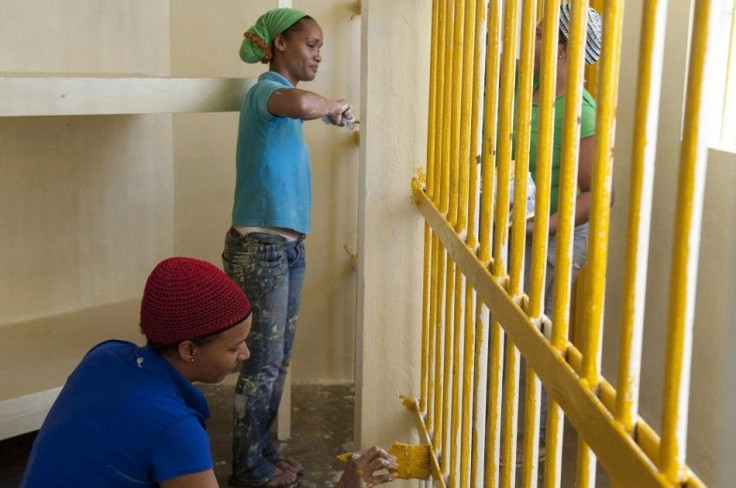 Prisoners paint their cell inside the renovated wing of the Najayo women's prison in San Cristobal, May 12, 2014. Ten years after the country opened its first prison designed with a focus on education and clean living conditions and staffed by graduates f