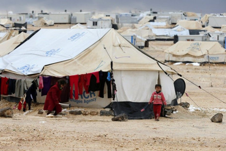 Syrian children play near a tent after a heavy snowstorm at Al Zaatari refugee camp in the Jordanian city of Mafraq, near the border with Syria, January 8, 2015. Syrian refugees in Jordan's main Zaatari refugee camp appealed for help on Thursday afte