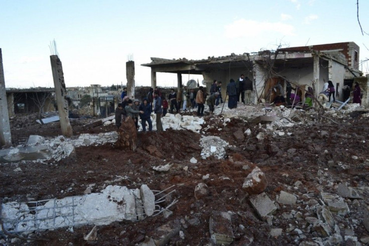 Civilians remove debris and search for survivors at a site hit by what activists said were airstrikes by forces loyal to Syria's President Bashar al-Assad in Jabal al-Zawiya in the southern countryside of Idlib January 4, 2015. Picture taken January 