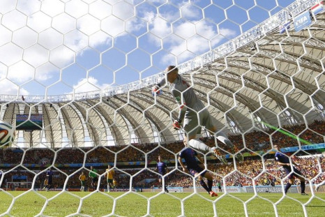 Australia's Tim Cahill (R) shoots to score against the Netherlands during their 2014 World Cup Group B soccer match at the Beira Rio stadium in Porto Alegre June 18, 2014. 