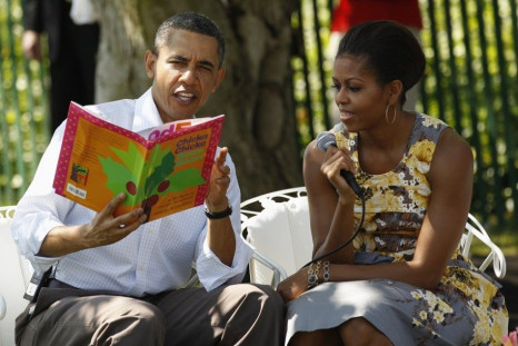 U.S. President Barack Obama and first lady Michelle Obama read a book titled &quot;Chicka Chicka Boom Boom&quot; to children during the annual Easter Egg Roll, at the White House in Washington April 25, 2011.