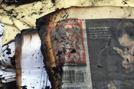 A burned copy of a Hamburger Morgenpost newspaper is pictured among other documents in front of a building of German newspaper Hamburger Morgenpost in Hamburg January 11, 2015. The building of German newspaper Hamburger Morgenpost was the target of an ars