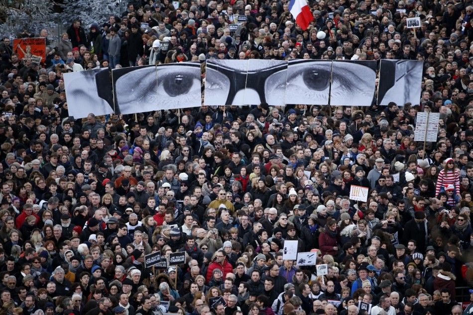 People hold panels to create the eyes of late Charlie Hebdo editor Stephane Charbonnier, known as quotCharbquot, as hundreds of thousands of French citizens take part in a solidarity march Marche Republicaine in the streets of Paris January 11, 2015
