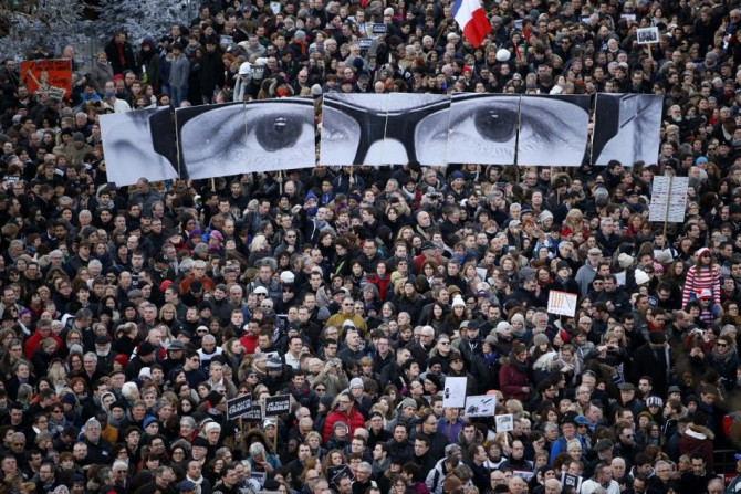 People hold panels to create the eyes of late Charlie Hebdo editor Stephane Charbonnier, known as &quot;Charb&quot;, as hundreds of thousands of French citizens take part in a solidarity march (Marche Republicaine) in the streets of Paris January 11, 2015