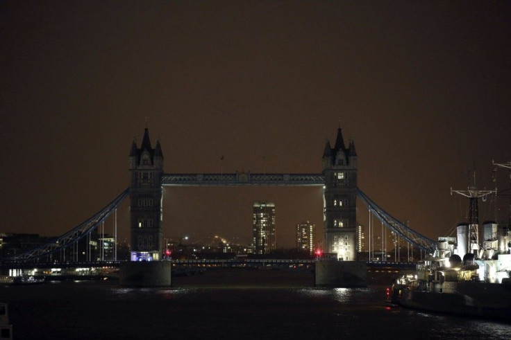 The lights of Tower Bridge are seen turned off to pay tribute to the 17 people killed in the Paris terror attacks, in London, January 11, 2015. People all over the world rallied on Sunday in an unprecedented tribute to this week's victims, including journ