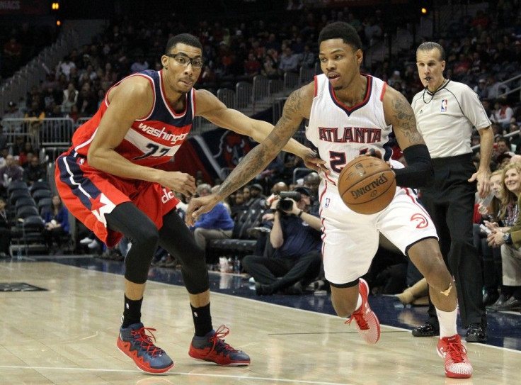 Jan 11, 2015; Atlanta, GA, USA; Atlanta Hawks guard Kent Bazemore (24) drives past Washington Wizards forward Otto Porter Jr. (22) in the fourth quarter at Philips Arena. The Hawks defeated the Wizards 120-89.