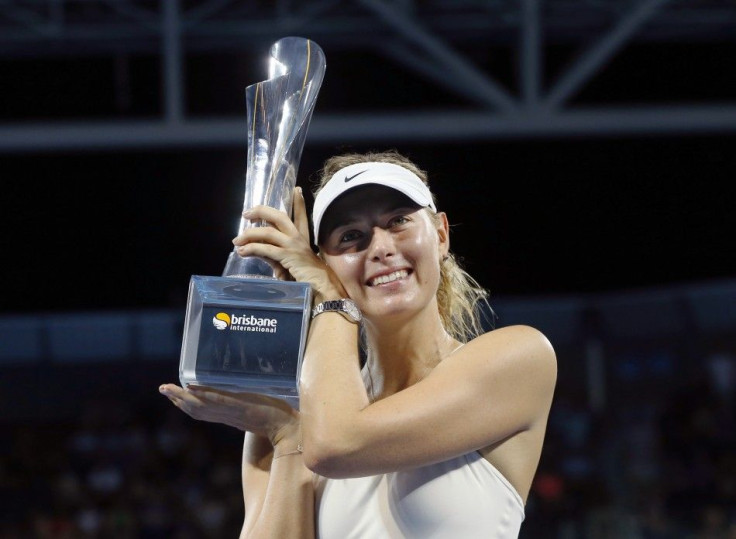 Maria Sharapova of Russia holds the Brisbane International tennis tournament women&#039;s singles trophy after defeating Ana Ivanovic of Serbia in Brisbane, January 10, 2015. REUTERS/Jason Reed