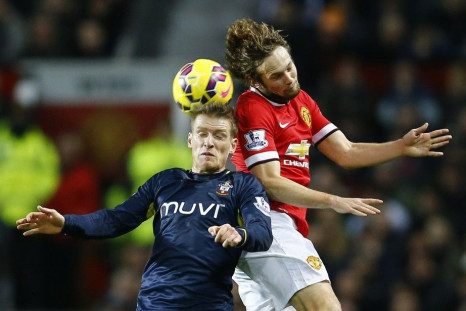 Southampton&#039;s Steven Davis (L) is challenged by Manchester United&#039;s Daley Blind during their English Premier League soccer match at Old Trafford in Manchester, northern England January 11, 2015.