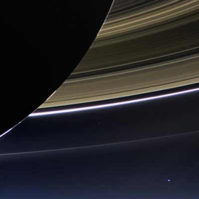 Saturn&#039;s rings and our planet Earth and its moon are seen in this image taken by the wide-angle camera on NASA&#039;s Cassini spacecraft July 19, 2013. Earth, which is 898 million miles (1.44 billion km) away in this image, appears as a blue dot at c