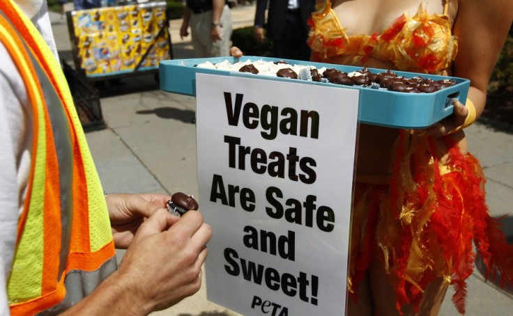A PETA (People for the Ethical Treatment of Animals) model dressed as a chicken hands out egg-free vegan cupcakes near the White House in Washington August 25, 2010. U.S. regulators on Monday were still investigating the massive salmonella outbreak that s
