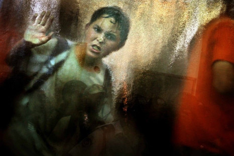 An angry Jewish settler boy looks out from inside a synagogue as Israeli policemen and solider storm inside in the Neve Dekalim settlement in the Gush Katif, August 18, 2005. Israeli troops stormed two Gaza Strip synagogues and dragged out screaming settl