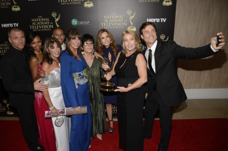 The cast and crew of "The Young and the Restless" pose backstage with the award for outstanding drama series during the 41st Annual Daytime Emmy Awards in Beverly Hills, California June 22, 2014.