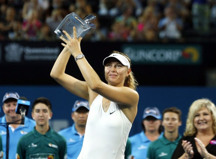 Maria Sharapova of Russia holds the Brisbane International tennis tournament women's singles trophy after defeating Ana Ivanovic of Serbia in Brisbane, January 10, 2015. REUTERS/Jason Reed
