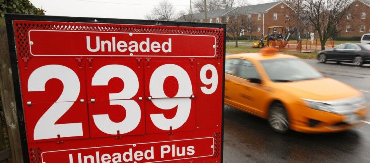 A taxi passes a gas station in Falls Church, Virginia December 16, 2014. For the first time in more than a decade, U.S. gasoline prices are tumbling toward $2 a gallon even as the economy grows and unemployment shrinks, a constellation that will test the 