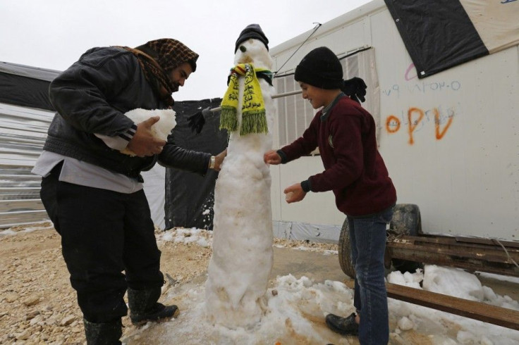 Syrian refugees make a snowman after a heavy snowstorm at Al Zaatari refugee camp in the Jordanian city of Mafraq, near the border with Syria, January 8, 2015. Syrian refugees in Jordan's main Zaatari refugee camp appealed for help on Thursday after a reg
