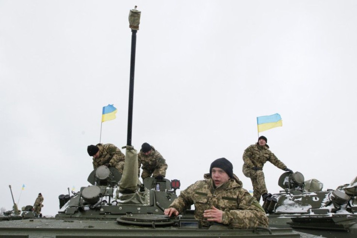 Ukrainian servicemen get inside armoured personnel carriers (APC) during a ceremony to hand over weapons, military equipment and aircraft to the army at a firing range outside Zhytomyr January 5, 2015. REUTERS/Valentyn Ogirenko