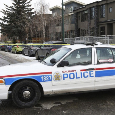Calgary Police cars block off a street were seven people were shot in a New Year&#039;s house party in the South West community of Killarney in Calgary, Alberta January 1, 2015. REUTERS/Jack Cusano