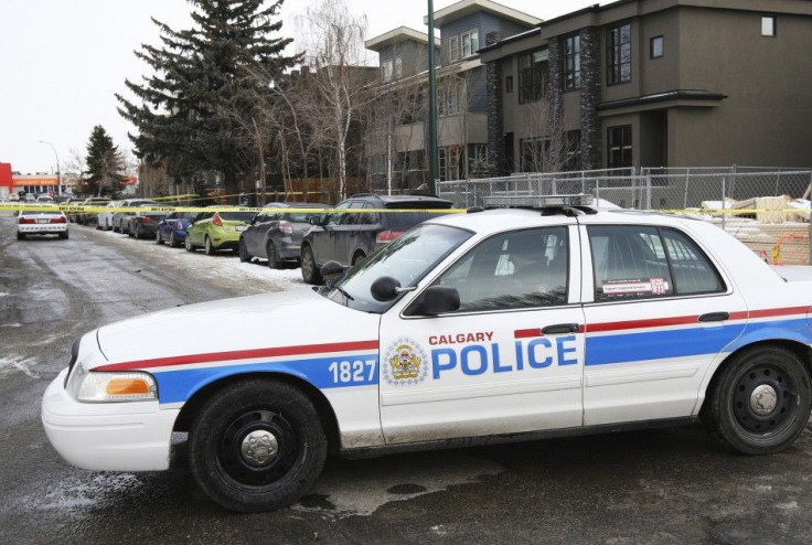 Calgary Police cars block off a street were seven people were shot in a New Year&#039;s house party in the South West community of Killarney in Calgary, Alberta January 1, 2015. REUTERS/Jack Cusano