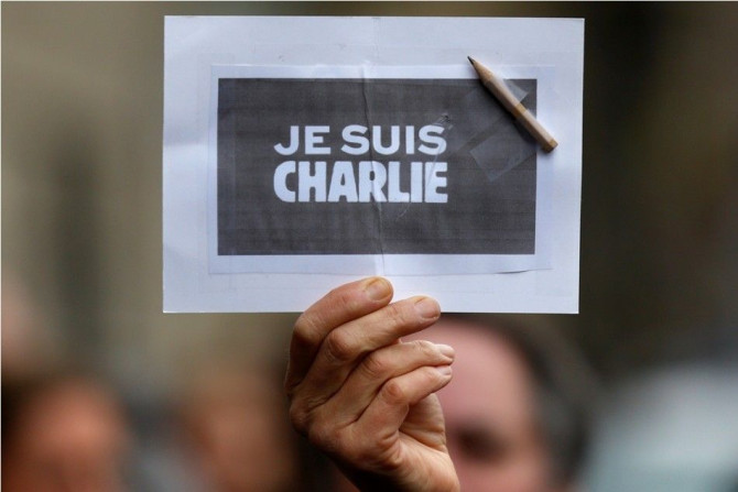 A person holds a placard with a pencil which reads &quot;I am Charlie&quot; during a minute of silence in Strasbourg