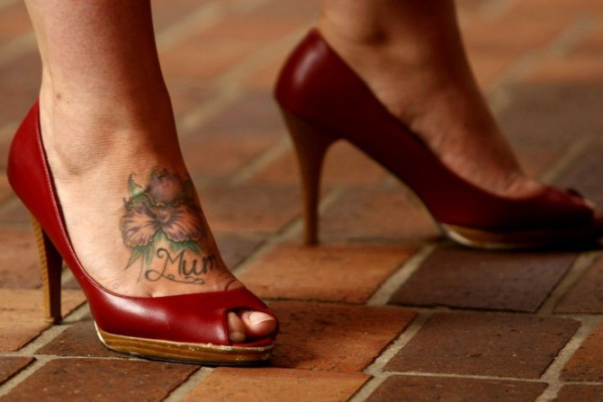 A sex worker sporting a tattoo on her foot participates in a protest in central Sydney