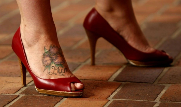 A sex worker sporting a tattoo on her foot participates in a protest in central Sydney