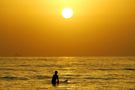 A surfer enjoys a cool surf at sunrise at Sydney&#039;s Manly Beach