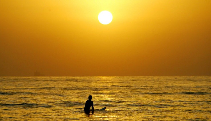 A surfer enjoys a cool surf at sunrise at Sydney&#039;s Manly Beach