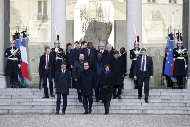 French President Francois Hollande (C), French Prime Minister Manuel Valls (L) and Paris Mayor Anne Hidalgo (R) leave with politicians from the Elysee Palace to take part in a solidarity march (Marche Republicaine) in Paris January 11, 2015. French citize