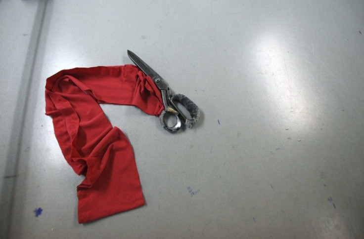 A pair of scissors and fabric are seen during a strike at Arena Moda factory in Pula March 10, 2014. Arena Tekstil employees from the Adriatic town of Pula went on strike in February after not being paid for at least four months. Ten months after Croatia 