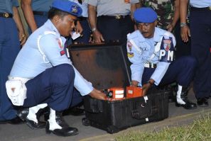 Indonesian Air Force soldiers show the cockpit voice recorder of AirAsia QZ8501 at Iskandar airbase in Pangkalan Bun, Central Kalimantan January 13, 2015. Indonesian divers pulled out the cockpit voice recorder from the sunken wreckage of an AirAsia passe