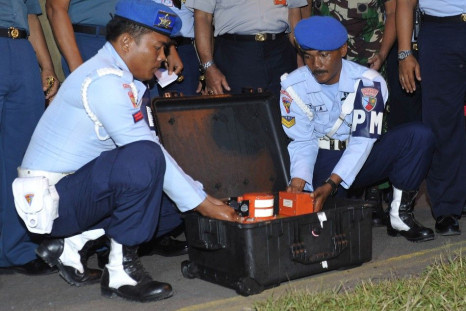 Indonesian Air Force soldiers show the cockpit voice recorder of AirAsia QZ8501 at Iskandar airbase in Pangkalan Bun, Central Kalimantan January 13, 2015. Indonesian divers pulled out the cockpit voice recorder from the sunken wreckage of an AirAsia passe