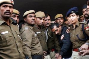 Policemen escort driver Shiv Kumar Yadav who is accused of a rape outside a court in New Delhi